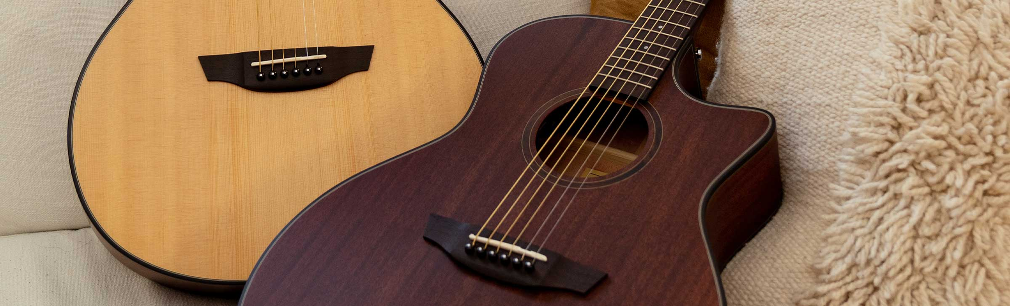 The Mason Live guitar played on a rustic chair.