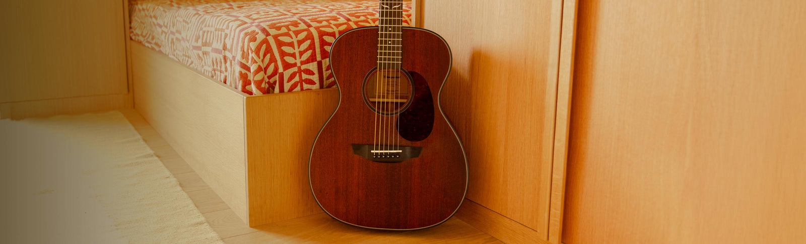 Oliver mahogany guitar on a rug